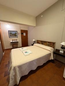 a bedroom with a large white bed in a room at Hotel Bonino in Villa Mercedes