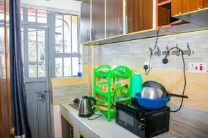 a kitchen with a counter with some dishes on it at One Bedroom Furnished in Kasarani-Nairobi in Nairobi