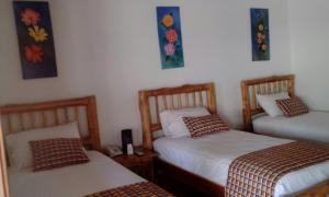 Postel nebo postele na pokoji v ubytování Hotel Brisas La Gaviota Mariquit-Tolima