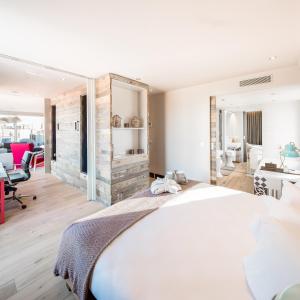 a bedroom with a large white bed and a desk at Generator Barcelona in Barcelona