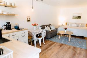 a living room with a bed and a kitchen at The Cozy Cottage in Moscow