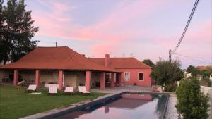 a house with a swimming pool in the yard at Casa da Mata in Torres Novas