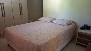 a bedroom with a bed with two pillows on it at Casa de Praia para Carnaval in Prado