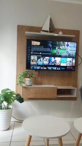 a flat screen tv on a wall at CasaNativa 7Sur in Curicó