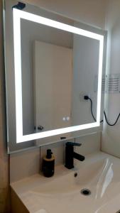 a bathroom sink with a large mirror above it at CasaNativa 7Sur in Curicó