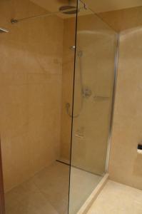 um chuveiro com uma porta de vidro na casa de banho em Apartament Agata em Świnoujście