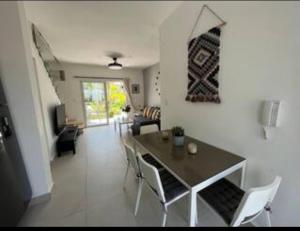 a dining room and living room with a table and chairs at Flamingo Villa in Boca Paraiso in Boca Chica