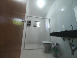 a bathroom with a shower and a toilet and a sink at Sobrado para show rural in Cascavel +7 photos