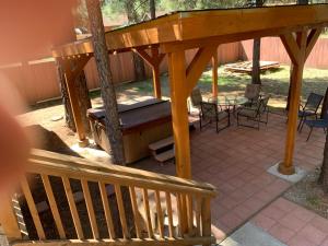 a wooden pergola with a table and chairs on a patio at TimberWood Cabin- 3 Bdr - 2 Bth - Big Game room - Prime Location in Big Bear Lake in Big Bear Lake