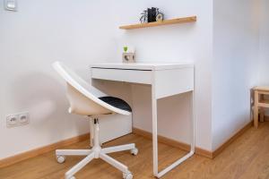a white desk with a chair next to a wall at Le Bretzel Petite Venise Vieille Ville City Center Wi-Fi in Colmar