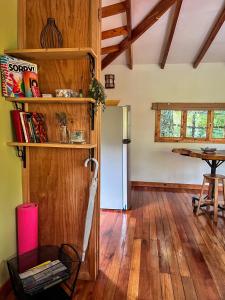 a living room with wooden floors and a refrigerator at Cabañita del Bambú, en Santa Maria de Dota in Higueronal