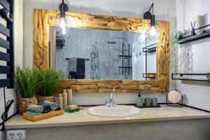 ein Badezimmer mit Waschbecken und großem Spiegel in der Unterkunft Charming Meets Modern Comfort - T2 Apartment in Ferragudo + 18 Fotos