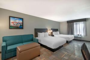 a hotel room with two beds and a couch at Best Western Plus Bluffton/Hilton Head Hotel in Bluffton +33 photos