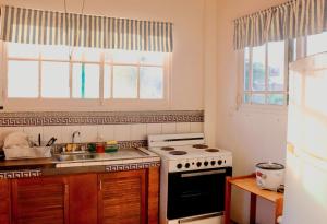 a kitchen with a stove and a sink at Terraza Suite Frente al Mar in Puntarenas +2 photos
