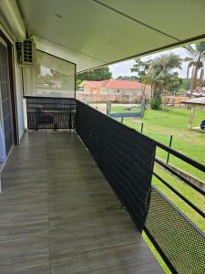 a porch of a house with a fence at Les Résidences primevère in Cayenne