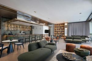 a lobby with couches and tables and a bar at Residence Inn by Marriott Santiago de los Caballeros in Santiago de los Caballeros