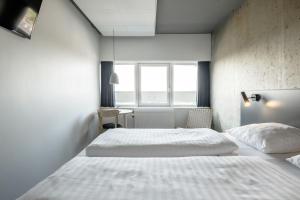 A bed or beds in a room at Four Points Flex by Sheraton Aarhus Viby