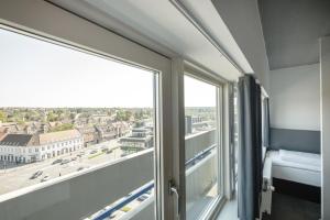 A bed or beds in a room at Four Points Flex by Sheraton Aarhus Viby