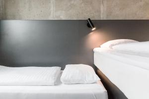 A bed or beds in a room at Four Points Flex by Sheraton Aarhus Viby