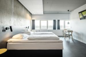 A bed or beds in a room at Four Points Flex by Sheraton Aarhus Viby