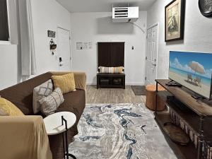 a living room with a couch and a flat screen tv at Quaint Monument Retreat studio in Grand Junction