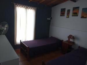 a bedroom with two beds and a window at Lo de Marito in Balneario Claromecó