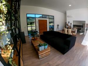 a living room with a black couch and a table at Naturaleza y tranquilidad in Salta