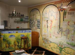 a kitchen with a large mural on the wall at Hotel Nova Cidade in Amadora