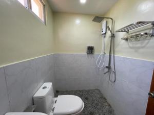 a bathroom with a toilet and a shower at SahaLand Siargao Guest House in General Luna +21 photos