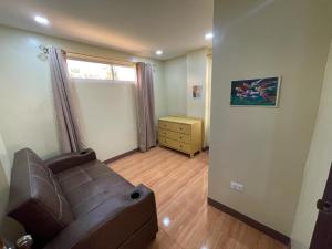 a living room with a couch and a window at SahaLand Siargao Guest House in General Luna