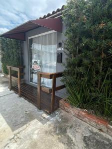 a small building with a window and a bench at Casa de São Francisco do Sul in São Francisco do Sul