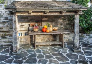 a wooden table with fruits and vegetables on it at Astra Inn in Papingo