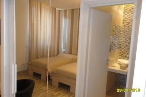 a bedroom with a bed and a sink and a mirror at Location Lory in Busto Arsizio
