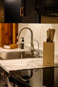 a kitchen with a sink and a counter top at TU CASA-pooltable-playset-sauna in Willmar +66 photos