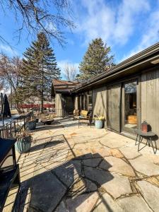 an outdoor patio with benches and a building at TU CASA-pooltable-playset-sauna in Willmar