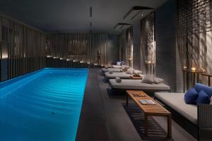 a hotel room with a pool and a row of beds at Mandarin Oriental, Milan in Milan