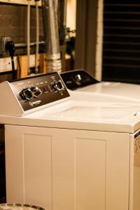 a stove top oven sitting on top of a white cabinet at MY FLAT! Industrial 3 Bd with outdoor space! in Willmar