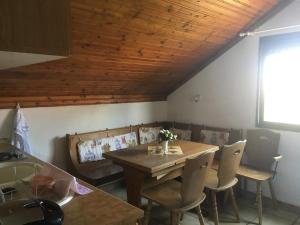 a dining room with a wooden table and chairs at Smaragda Suite Vrasna Beach in Nea Vrasna