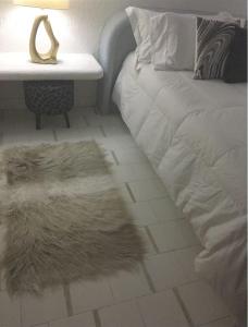 a bedroom with a bed and a table with a rug at COZUMEL-1 Bed 1 Ba PARADISE in Cozumel +16 photos