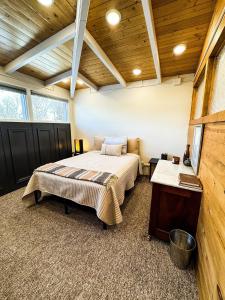 a bedroom with a bed and a wooden ceiling at MY PLACE! Luxury 2 Bed with piano! in Willmar