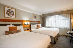 a hotel room with two beds and a window at Listel Whistler, a Coast Hotel in Whistler