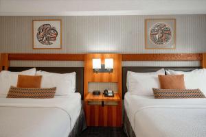 a hotel room with two beds and a night stand at Listel Whistler, a Coast Hotel in Whistler