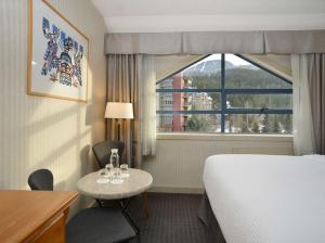 a hotel room with a bed and a window at Listel Whistler, a Coast Hotel in Whistler