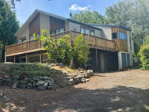 a large house with a deck and a yard at 5 Alpine Avenue in Hanmer Springs