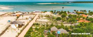 an aerial view of a beach with houses and the ocean at Pousada Lunar in Parnaíba
