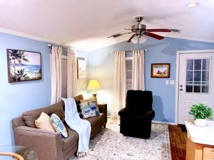 a living room with a couch and a ceiling fan at The Tranquil Cabin in Dover