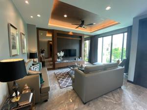 a living room with a couch and a ceiling fan at villa kamala regent 2 bedrooms in Kamala Beach