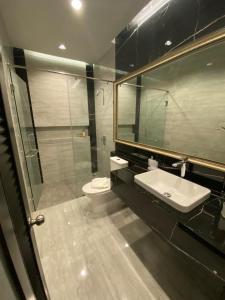 een badkamer met een wastafel, een toilet en een spiegel bij villa kamala regent 2 bedrooms in Kamala Beach