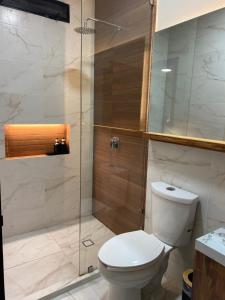 a bathroom with a toilet and a glass shower at Bacaanda #2 in Oaxaca City