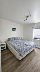 a bedroom with a bed and a window in it at Koselig leilighet med balkong og parkering. in Stavanger